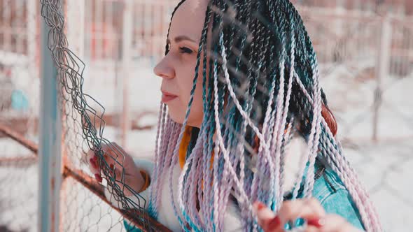 Stylish Woman Leaning on Metal Fence