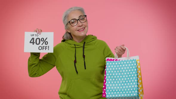 Senior Granny Woman Showing Shopping Bags and Up To 40 Percent Off Inscriptions Banner Black Friday