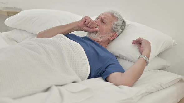Coughing Sick Old Man Lying in Bed