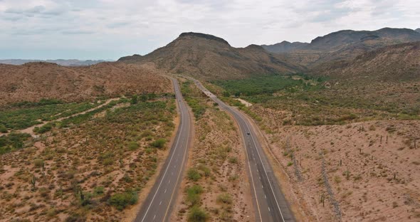 Dramatic Clouds Over the Mountains are a Desert Cactus Mountain Landscape Near the Highway in