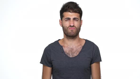 Caucasian Bearded Guy with Chest Hair Under Grey Tshirt Nodding Negatively Expressing Total