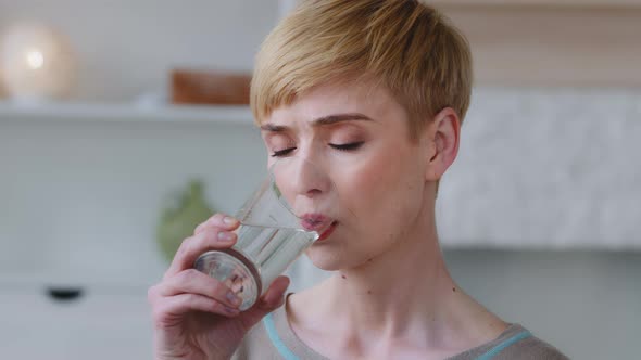 Close Up View Woman Reduces Thirst Takes a Sips Drinking Glass of Natural or Mineral Water
