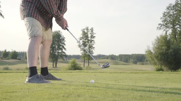 Unrecognized Man Playing Golf Hitting Golf Ball on the Golf Course