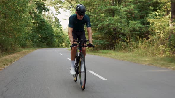 Portrait of cyclist man training on road bike