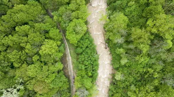 Flight over a mountain river in the forest