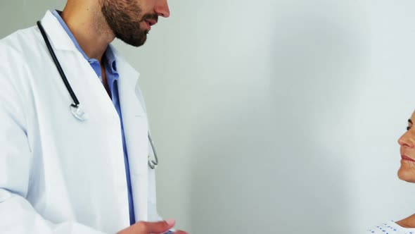 Male doctor comforting patient in the ward