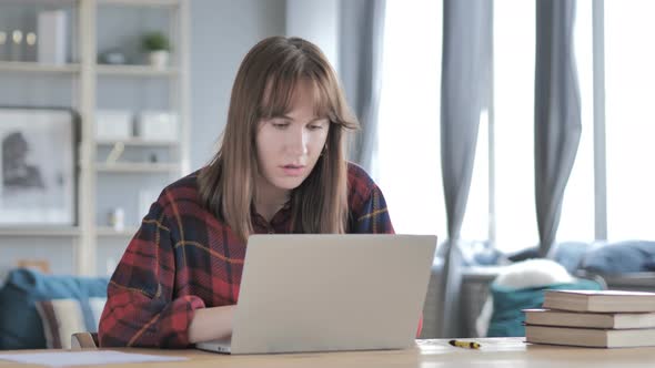 Thinking Young Woman Working o Laptop