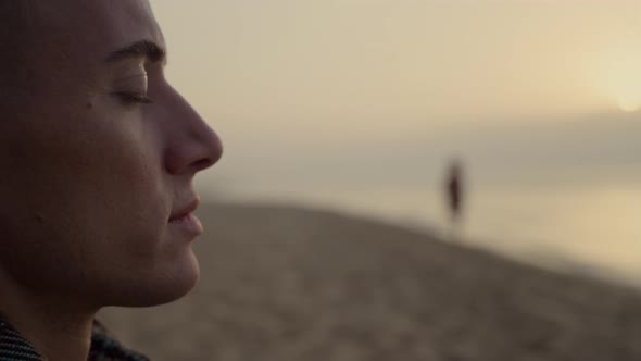 Thoughtful Man Enjoying Ocean Landscape at Sunset