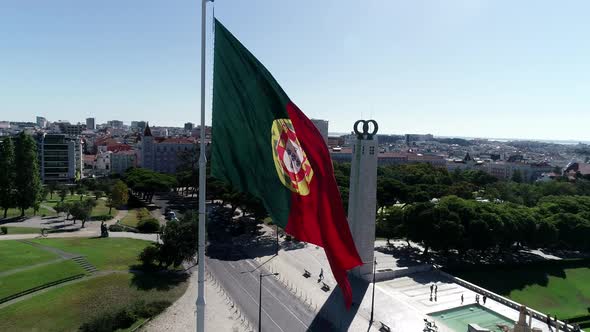 Close Up Aerial View of Portugal Flag Waving in the Wind on Eduardo VII Park Lisbon