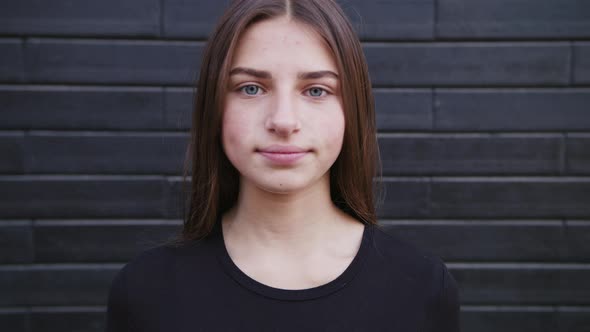 Portrait of a Very Beautiful Modern Cute Girl Who Laughs and Looks at the Camera. The Wind Plays