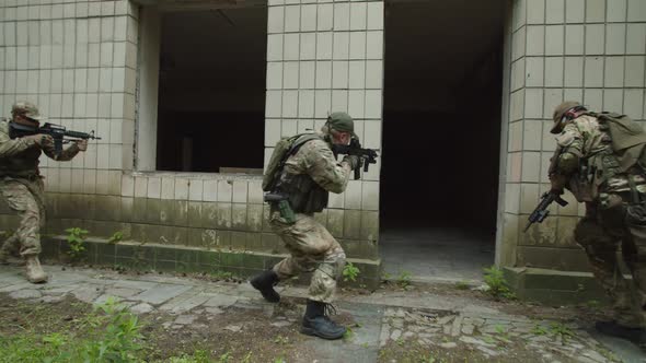 Special Forces Military Group Assaulting Building Applying Grenade