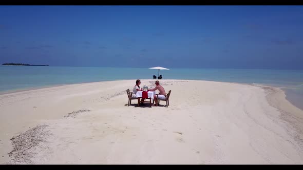 Man and lady in love on exotic bay beach wildlife by turquoise ocean and white sand background of th