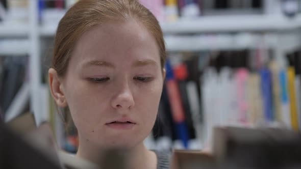 Close Up of Woman Searching for Book in Library