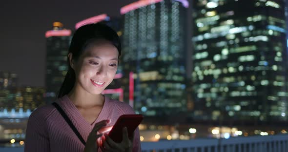 Woman check on mobile phone at night