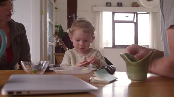 Caucasian baby eating strawberries at home