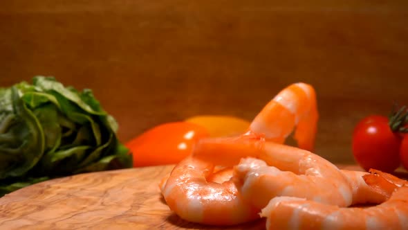 Delicious Peeled Shrimp Fall on a Wooden Board