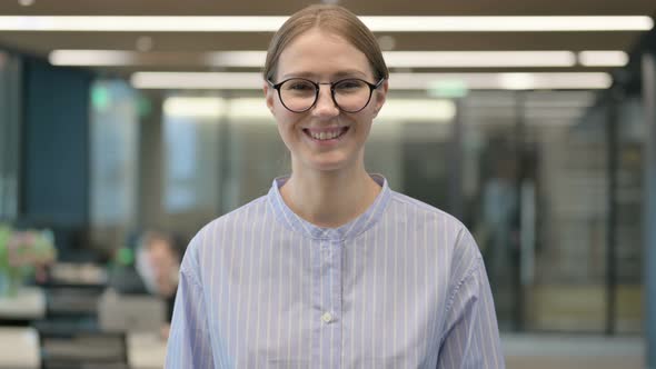 Portrait of Attractive Young Woman Smiling at Camera