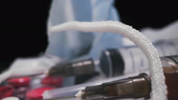 Syringe with Vaccine and Different Drugs on Black Background