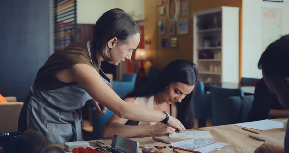 Master in the Linocut Will Explain Something to the Student Girl