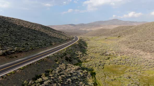 Aerial View of Scenic Road in the Middle of Green Desert Valley in Mono County