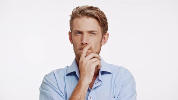 Unapproving Caucasian Male with Brown Beard and Blue Eyes on White Background