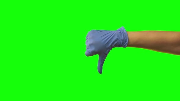 Hand Woman in Blue Glove Showing Showing Thumb Down Gesturing Dislike. Green Screen. Close Up
