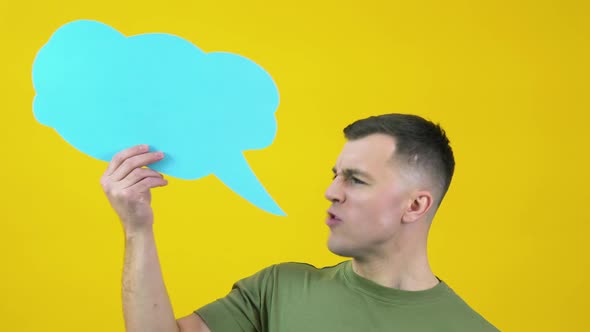 A Man in a Green Tshirt Holds a Cloud for Insert Text and Shouts a Message Slogan or Song Out Loud