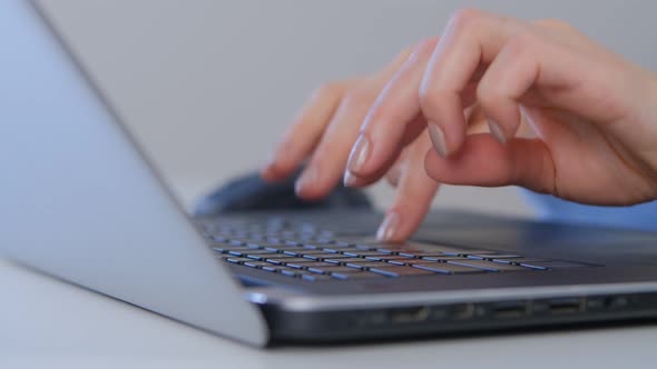 Freelance writer writing text on laptop computer keyboard in 4k video