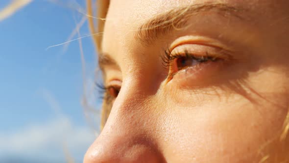 Close-up of young caucasian woman standing at beach 4k