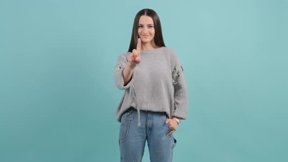 Wonderful Woman That Showing No with Her Finger Poseing Over Turquoise Background