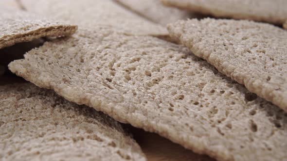 A pile of dietary buckwheat crispbread. A crispy healthy cracker with a textured porous crust