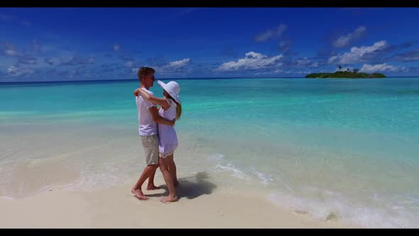 Man and lady sunbathing on beautiful seashore beach adventure by blue lagoon with white sand backgro