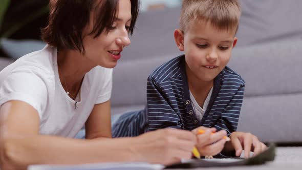 Boy with Mother Drawing