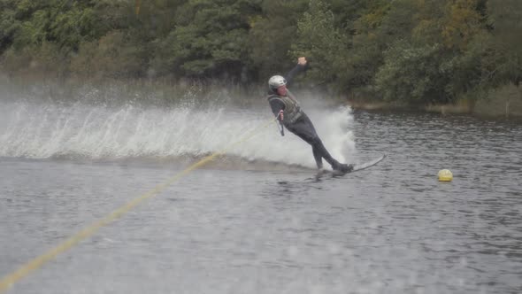 Water-skier slalom ski cuts wide around buoy