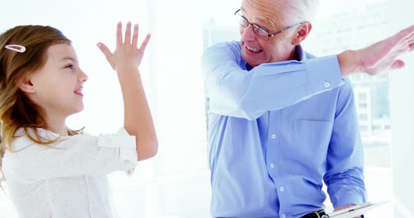 Male doctor and patient giving high five