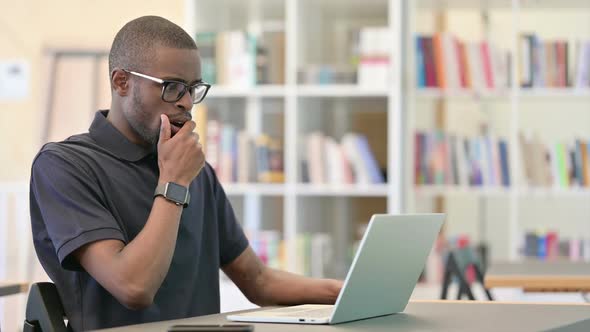 Worried Young African Man with Laptop Feeling Shocked on Laptop