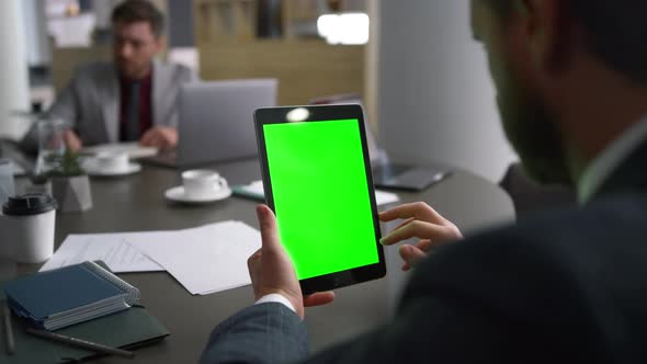 Executive Man Scrolling Tablet Chroma Key Looking Business News Media in Office