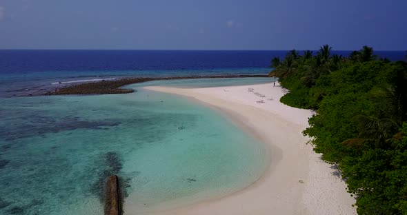 Wide birds eye copy space shot of a white paradise beach and blue water background in colorful 