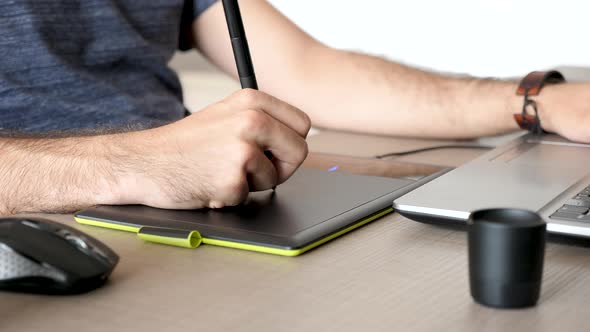 Graphic Artist Working on a Digital Tablet