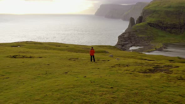 Aerial View of Man Resting After Walking Looking Coast Landscape