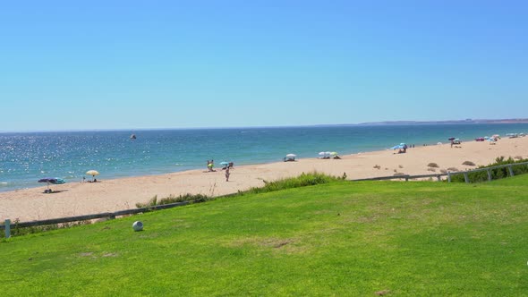 Grassy Field Near a Pleasant Looking Beach and Glistering Ocean Water in Vale Do Lobo Portugal