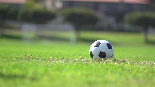 A man playing soccer on a grassy field.