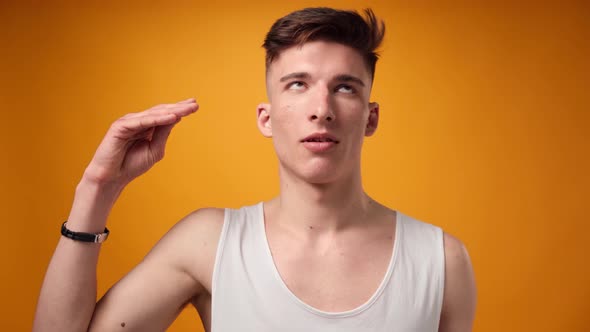 Young Caucasian Man Showing Blabla Sign Against Yellow Background
