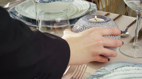 Close Up of Woman Putting Candle on Table