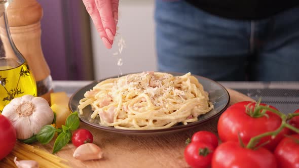 Making Pasta Carbonara  Pouring Grated Parmesan Cheese Spaghetti in Ceramic Dish