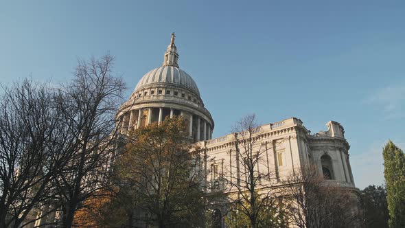 Popular London tourist attraction and landmark of St Pauls Cathedral on a bright blue sky day with A