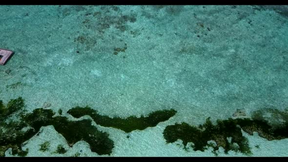 Aerial above landscape of tranquil shore beach time by turquoise water with white sand background of