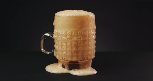 Pouring Beer Into Glass Over Dark Background