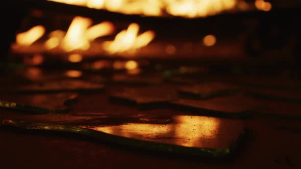 Flames reflected in broken glass