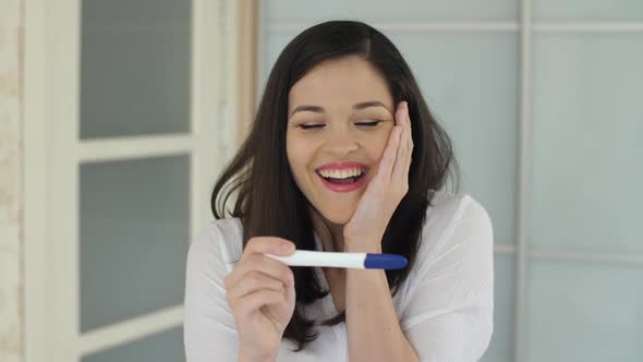 Surprised Woman with Pregnancy Test